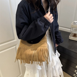 Brown suede crescent bag with long fringes, bohemian crossbody style for summer 2025