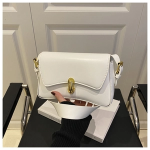 Detail of white leather baguette bag featuring a cylindrical gold metal twist lock