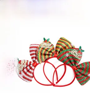 Detail of Christmas bow headbands with glitter stripes and Feliz Navidad golden ornaments