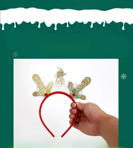 Close-up of a Christmas headband with golden glitter antlers and white plush snow base