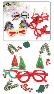 Close-up of glittery Christmas tree and reindeer antler party glasses with Merry Christmas text
