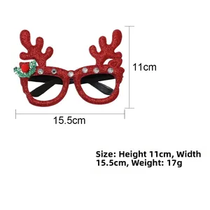 Detailed view of red glitter reindeer antlers glasses with white rhinestones and festive pom-poms