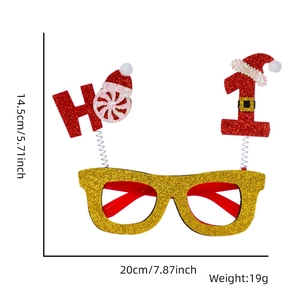 Detail of Christmas party glasses with gold glitter frame and festive HO red hat decor