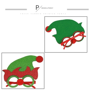 Detail of Christmas elf hat glasses with glitter coating and festive red pom-pom
