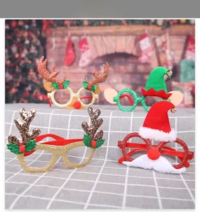 Macro detail of four assorted Christmas glasses featuring glitter reindeer antlers and elf hats