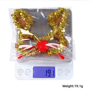 Christmas reindeer antlers headband with gold sequins weighing 19.1g on a scale