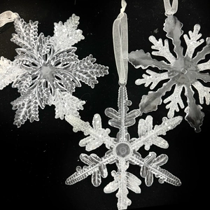 Set of clear acrylic Christmas snowflake ornaments with white glitter and sheer ribbons