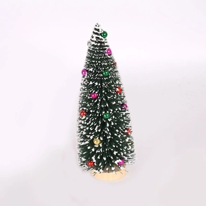 Mini cedar Christmas tree with white flocking and colorful baubles on wooden base