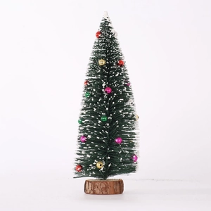Mini flocked Christmas tree with colorful ornaments and a natural wooden base for desk decor