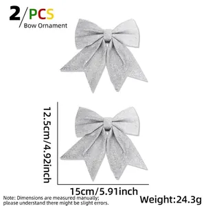 Detailed size view of two silver glitter Christmas bows measuring 15cm by 12.5cm