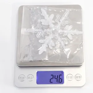 Detailed weight measurement showing a 24.6g clear acrylic Christmas snowflake ornament