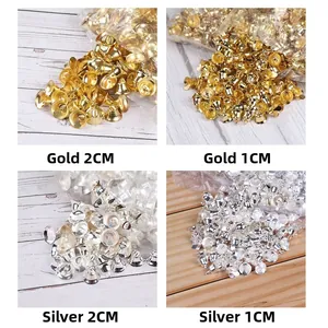 Close-up of gold and silver Christmas bells in 1cm and 2cm sizes for DIY decoration