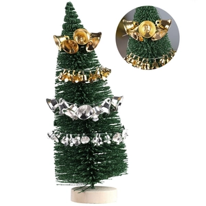 Gold and silver Christmas metal bells hanging on a mini tree with wooden base