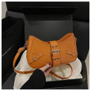 Detail of orange crocodile pattern crossbody bag with silver buckle in luxury gift box
