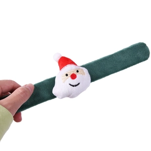 Detail of green plush Christmas slap bracelet with cute 3D Santa Claus figure decoration