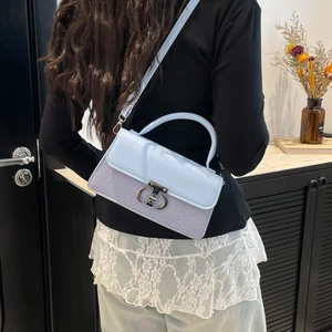 Elegant light blue leather and striped fabric handbag for women with silver metal buckle