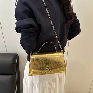 Golden crocodile pattern square crossbody bag with metallic V-shaped clasp and chain strap