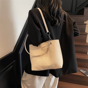 Minimalist off-white pebbled leather tote bag with silver chain straps for office wear