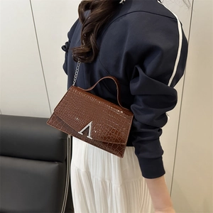 Brown crocodile embossed small square bag with silver V buckle and chain strap