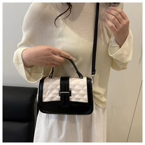 Chic quilted square bag with black and white contrast leather and metal buckle clasp