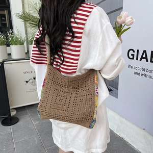 Handmade crochet shoulder bag with colorful patchwork strap and geometric hollow pattern