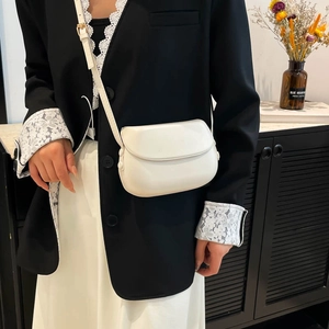 Minimalist white semi-circular crossbody bag for women with flap and thin shoulder strap
