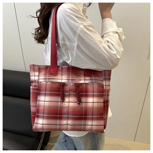 Close-up of red and white checkered tote bag with reinforced nylon straps and zipper detail