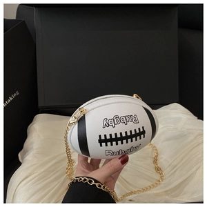 Detailed macro view of rugby-shaped crossbody bag with white lychee texture and gold chain
