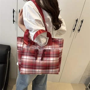 Large red plaid tote bag with dual front pockets and woven zipper details for women