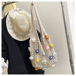 Detail of floral knit tote bag featuring colorful 3D crochet flowers on beige fabric