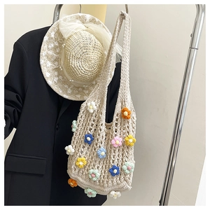 Close-up of handmade crochet underarm bag with multi-colored 3D floral embroidery