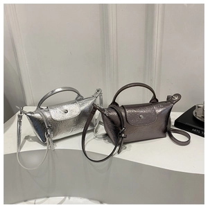 Detail of silver and gunmetal trapezoid bags featuring metallic pleated texture