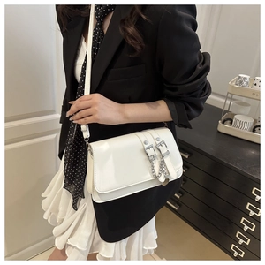Detail of white minimalist crossbody square bag with silver hardware and chain strap