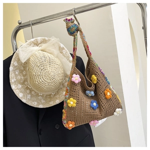 Detail of bohemian handmade crochet tote bag with colorful 3D floral patterns and textures