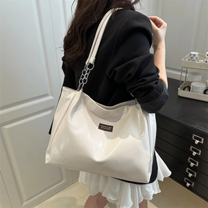 Chic beige high-capacity tote bag in glossy PU leather with elegant metal chain strap
