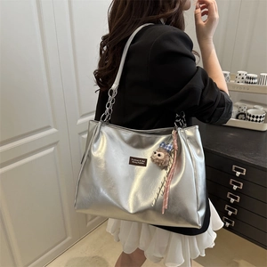 Silver metallic leather tote bag with chain strap and cute charms for summer style