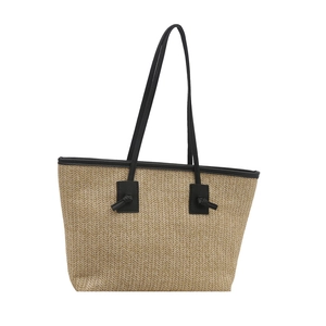 Handwoven straw beach tote bag with black leather straps and summer chevron texture