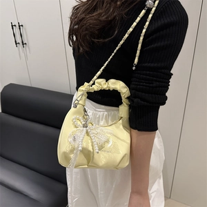 Light yellow pleated crescent bag with pearl lace charm and silver chain strap