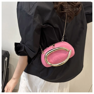Detailed view of pink glossy pillow bag featuring silver metallic oval buckle and chain strap