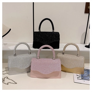 Detail of four glittering square handbags in black, silver, pink, and champagne gold colors
