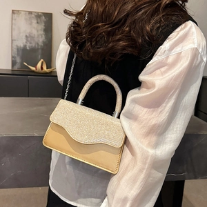 Elegant champagne mini handbag with shimmering crystal handle and gold leather strap