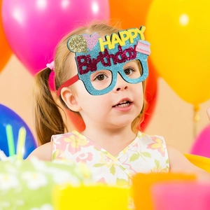Kids happy birthday party glasses in blue glitter with heart and balloon decorations