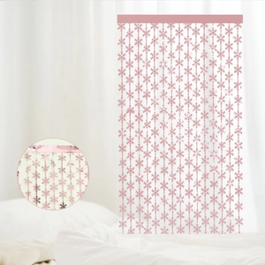 Close-up of pink snowflake foil fringe curtain with detailed texture in a circle inset