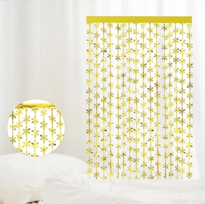Detail of gold snowflake foil curtain with metallic PET texture for party backdrop decor