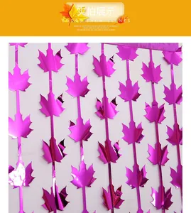 Detail of purple maple leaf fringe curtain with shiny metallic foil for party decor