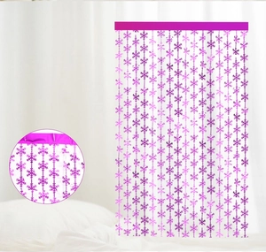 Close-up of purple snowflake tinsel fringe curtain with shiny metallic foil texture