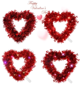 Detail of red heart tinsel wreath ornaments with LED lights for Valentine decorations