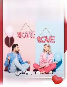 Detail of wooden LOVE hanging signs with heart patterns and red checkered bows for Valentine
