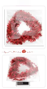 Detailed view of red tinsel heart wreath with 33cm x 36.5cm size and 68g weight data