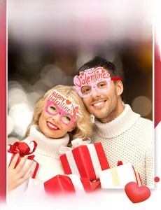 Close-up of pink Valentine's Day DIY glasses with heart and Cupid motifs on a couple